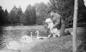 Charles Croft playing with an infant while in uniform.  Date: [1917]  Source: Saanich Archives, 2013-014-001