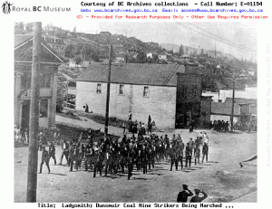 Striking coal miners at Ladysmith being marched to jail. Source: Image Courtesy of Royal BC Museum, BC Archives - Call Number: E-01194 See BC Archives Date: 1913